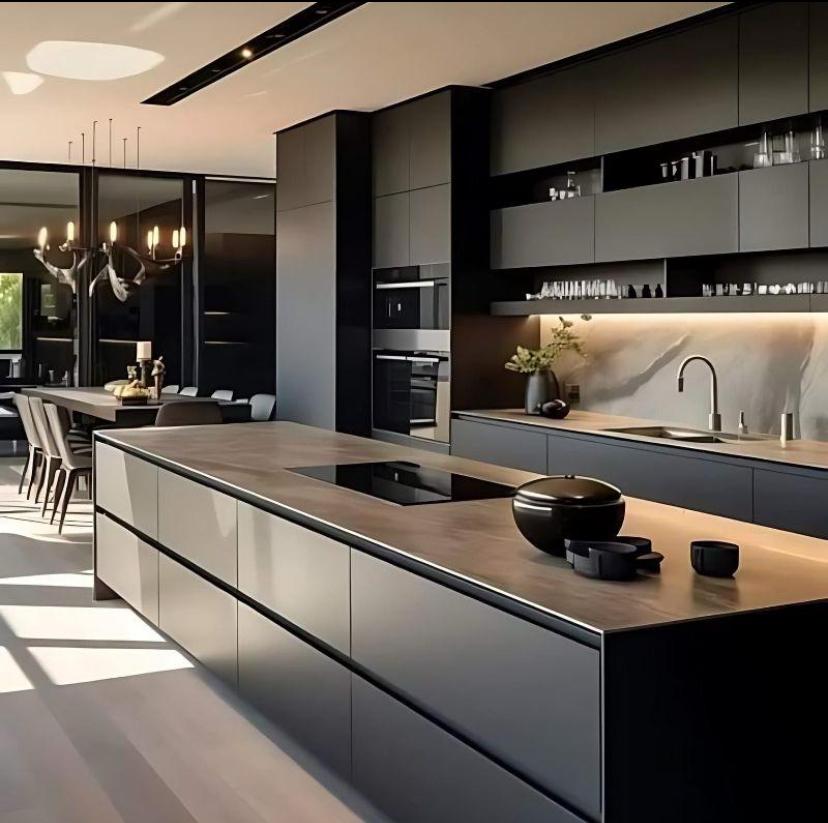 Dark island kitchen with antler chandelier and dining beyond — Coastal Modern Concept, Palm Coast, FL