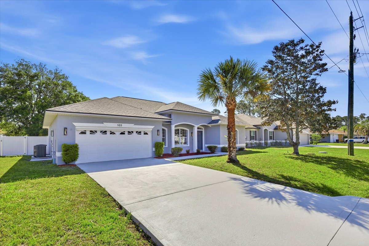 The Royal Palms House — front exterior with palm tree, Palm Coast, FL